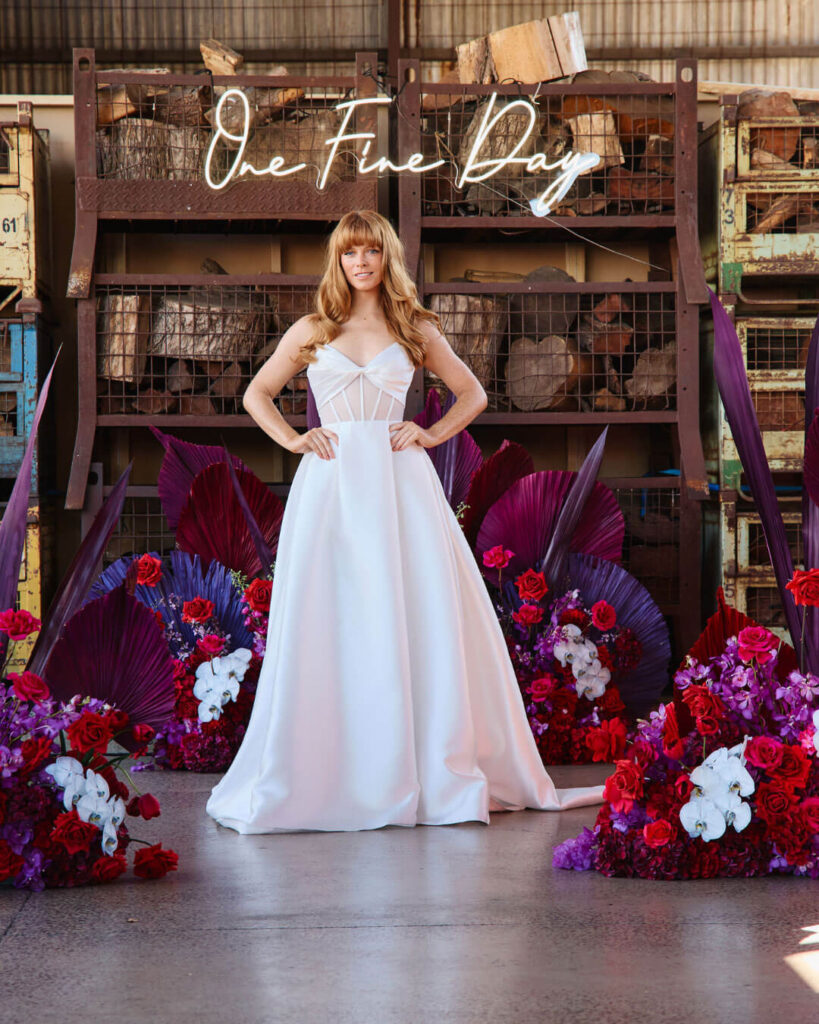 Model posing in a corset top ball gown wedding dress at a bridal runway show in Melbourne.