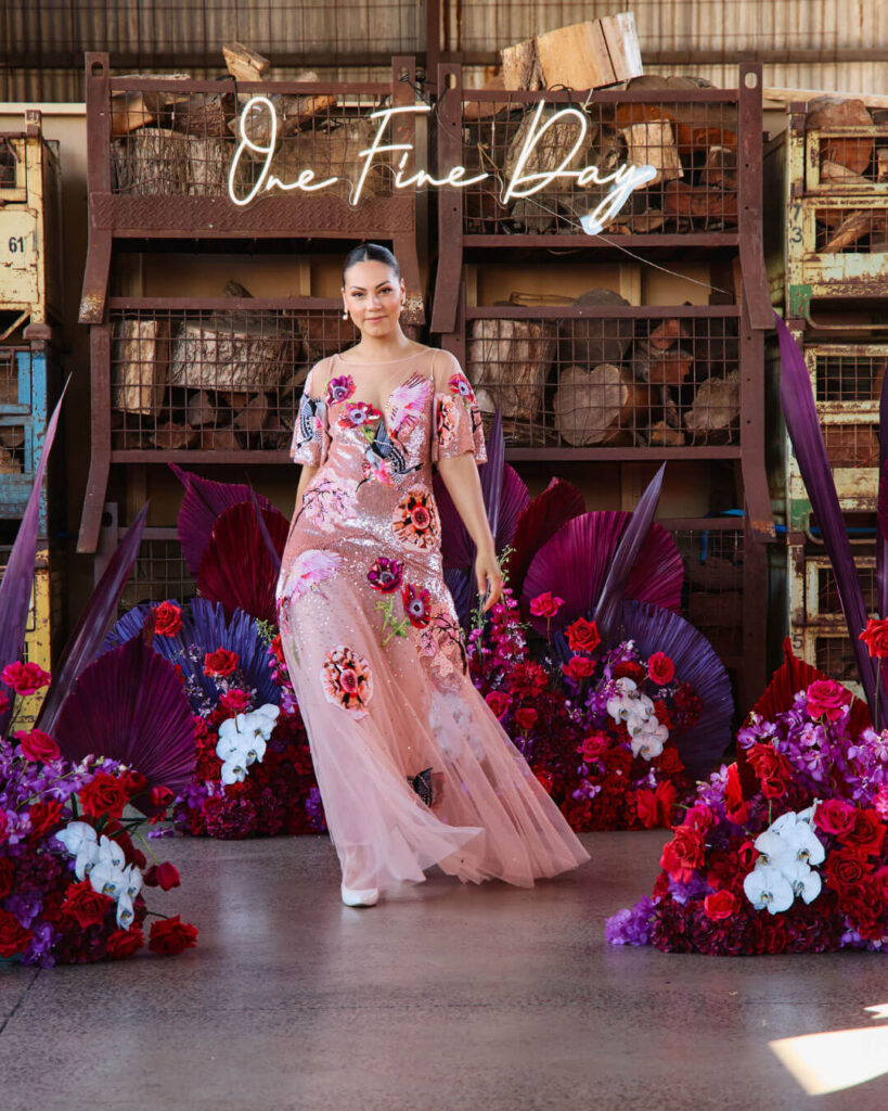 Elegant pink floral detail wedding dress with flowing tulle floral skirt showcased during a bridal runway show in Melbourne.