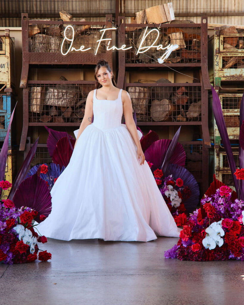 Model posing in a sleeveless ball gown wedding dress at a bridal runway show in Melbourne.