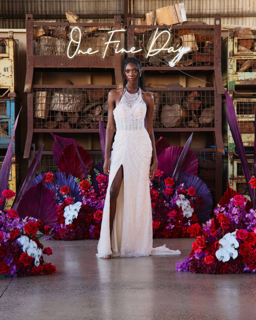 Bridal runway show in Melbourne featuring an elegant halter wedding gown with daring thigh-high slit