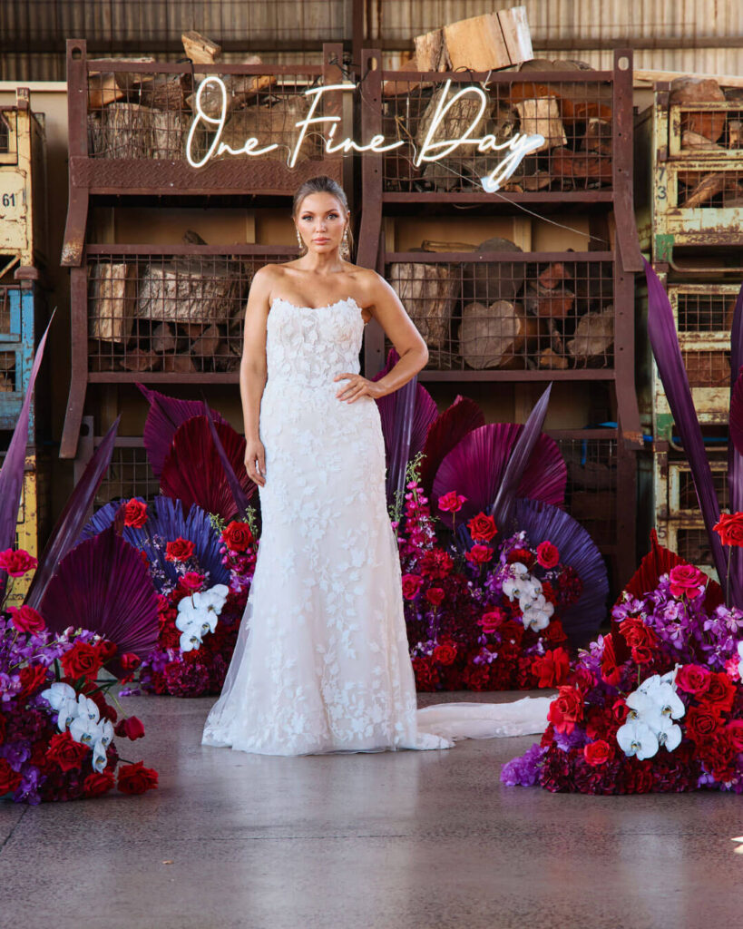 Strapless fitted lace wedding gown with intricate detailing showcased during a bridal runway show in Melbourne.