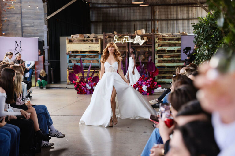 Model walking towards the camera in a wedding gown at the Wedding Expo in Melbourne.