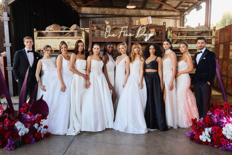 Models dressed in black and white gowns and suits walking the runway at Melbourne’s wedding expo