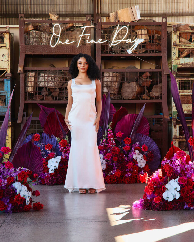 Model posing in a sleeveless satin wedding dress at a bridal runway show in Melbourne