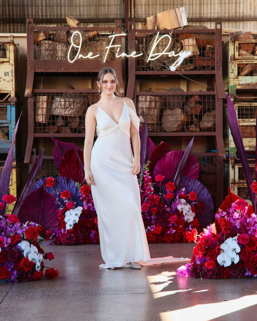Bridal runway show in Melbourne featuring a modern strappy satin bridal gown with plunging deep V-neckline.