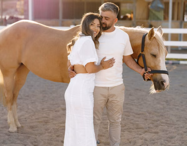 Venues Listing Category South East Equestrian Club Couple beside brown horse from South East Equestrian Club Horse Hire for Photoshoot.
