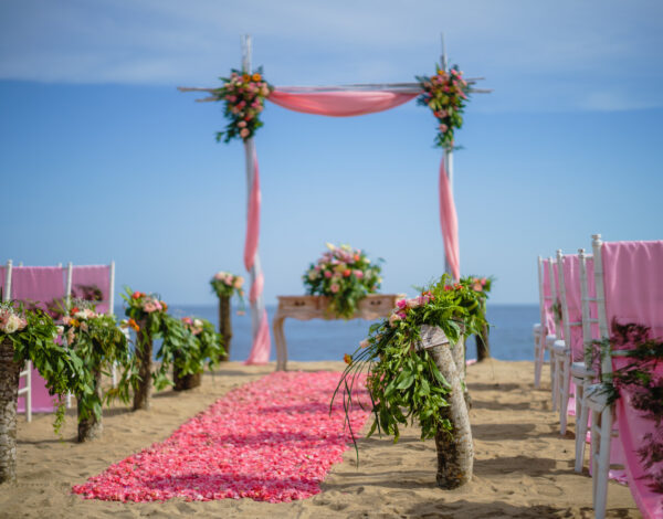 Venues Listing Category Kayumanis Sanur Private Villa & Spa Stunning pink beach wedding arch and seating at Kayumanis Sanur Private Villa & Spa Bali Destination Wedding.