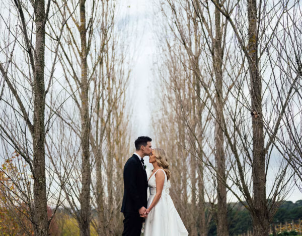 Venues Listing Category Polperro Winery Group Scenic outdoor wedding moment at Polperro Winery, Mornington Peninsula wedding venue with tall trees.