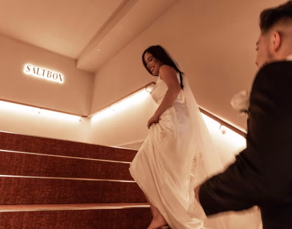 Venues Listing Category Saltbox Romantic bride and groom chasing each other on the staircase at Saltbox Wedding Venue in Sydney.