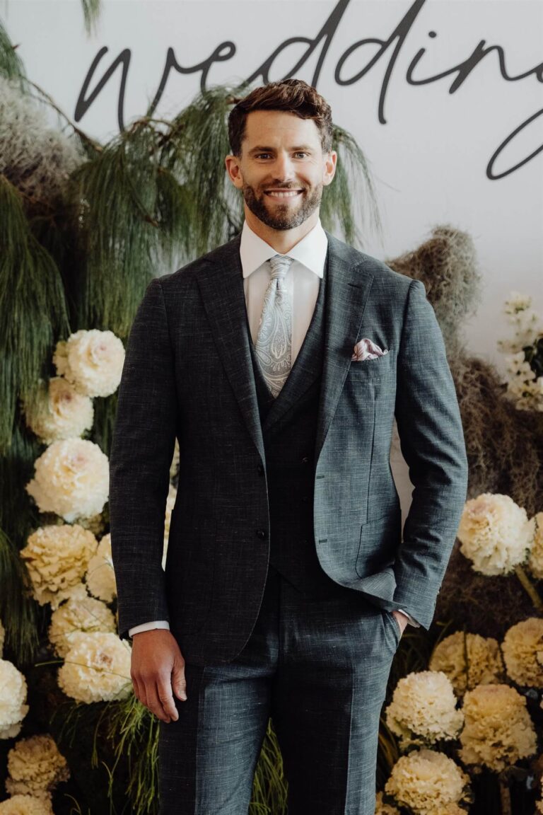 Close-up of model walking wearing black vest, suit, and pants at wedding expo in Sydney 2025