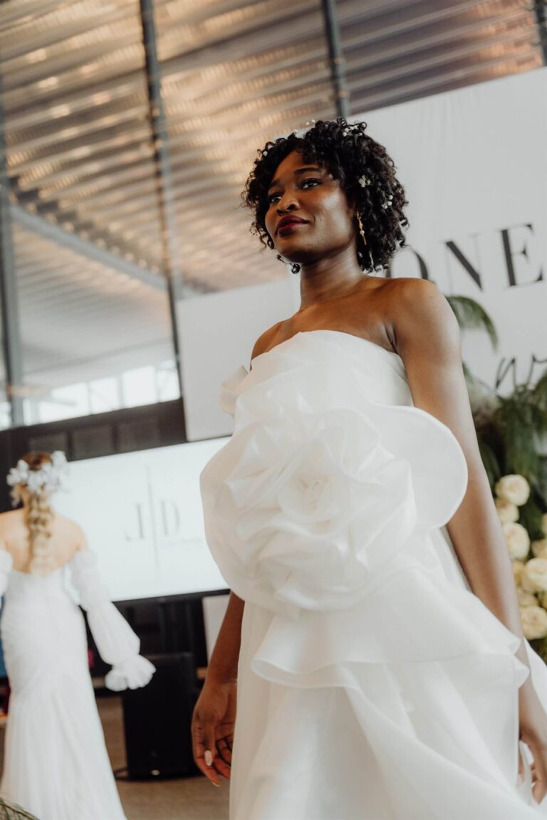 Elegant tube-style satin dress adorned with large rose on side showcased at the wedding expo in Sydney 2025