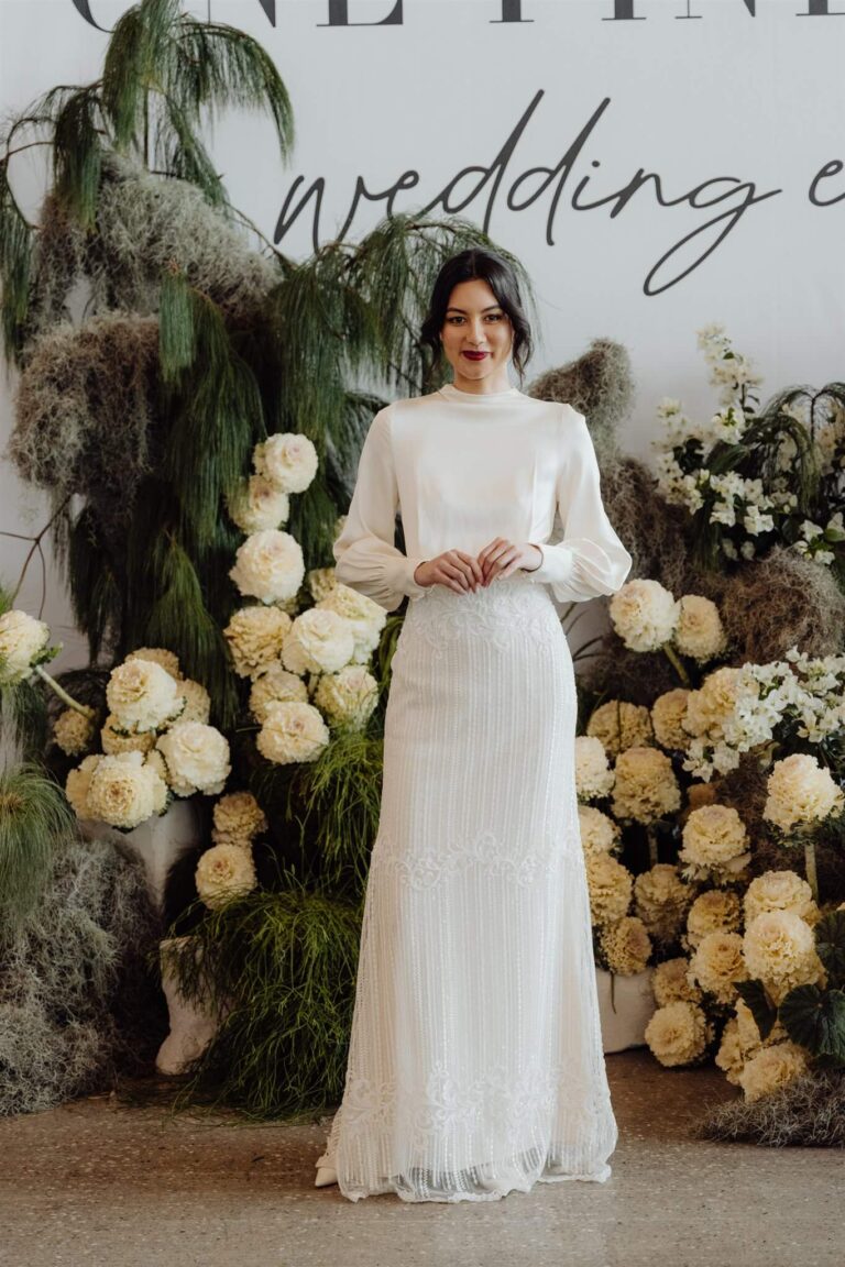 Close-up of leaf detail on long sleeve high neckline chiffon gown during wedding expo in Sydney 2025