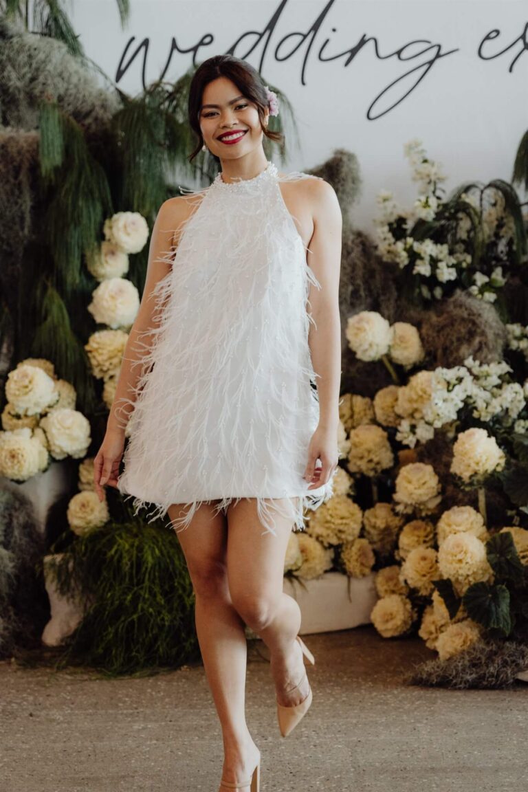 Model showcasing elegant dress ending above the knee at the wedding expo in Sydney 2025
