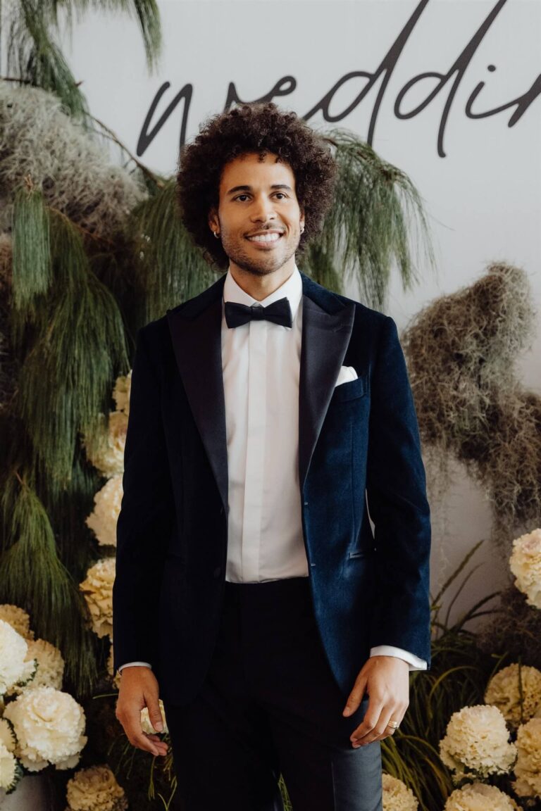 Close-up of model in navy blue velvet suit and black satin pants during wedding expo in Sydney 2025