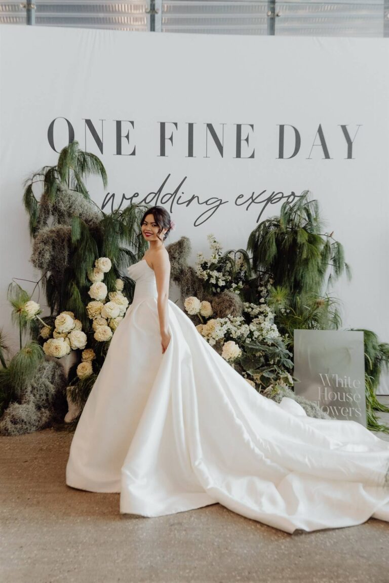 Side view of model wearing long satin gown at bridal runway show in Sydney 2025