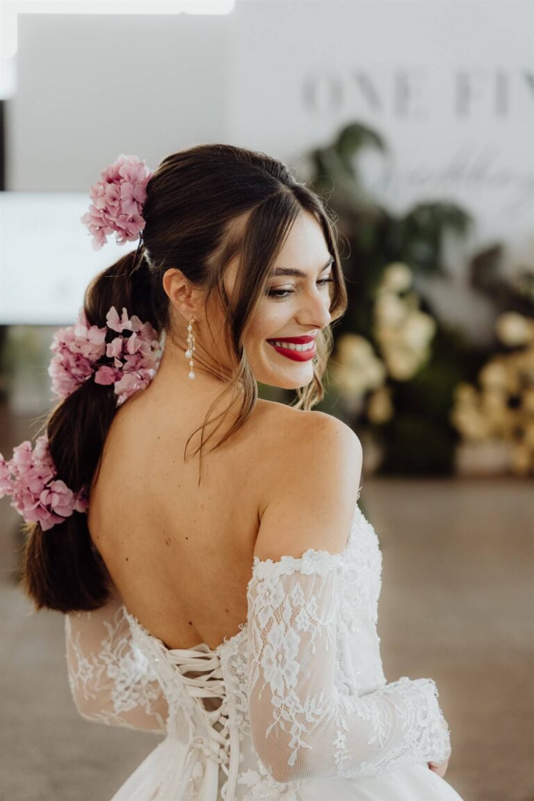 Back view of bridal runway show model with floral hair accessory at wedding expo in Sydney 2025