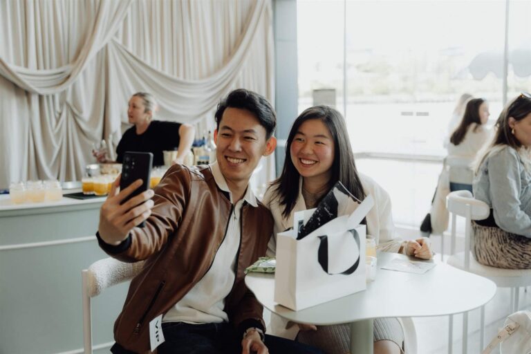Smiling visitor capturing selfie moment during wedding expo in Sydney 2025