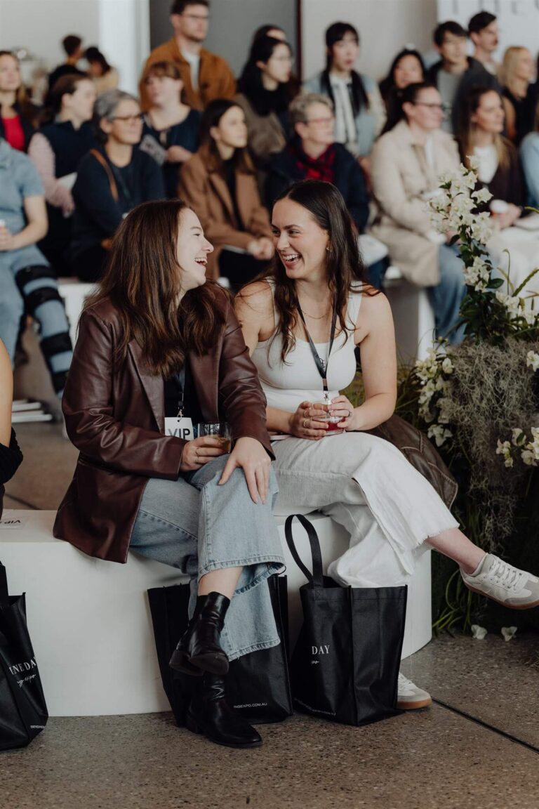 Two exhibitors laughing together at wedding expo in Sydney 2025