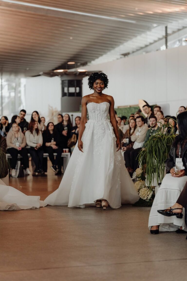 Designer gown displayed by model walking to camera at wedding expo in Sydney 2025