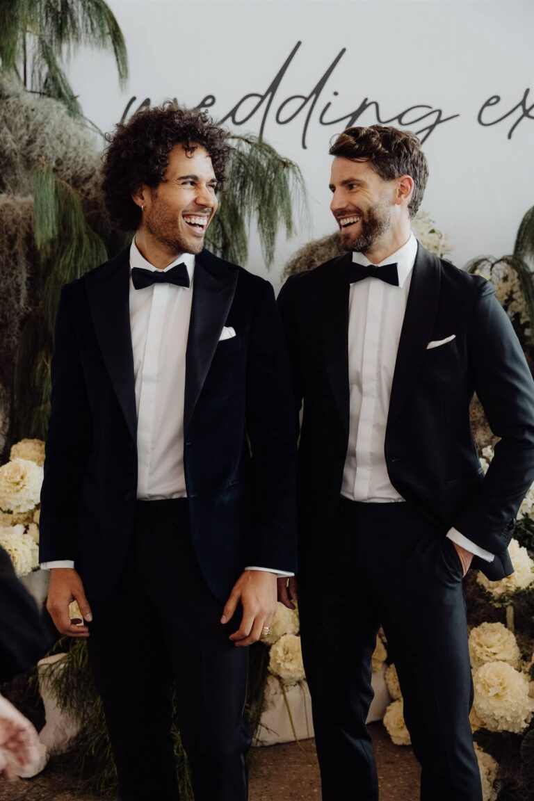 Two men models laughing together at wedding expo in Sydney 2025
