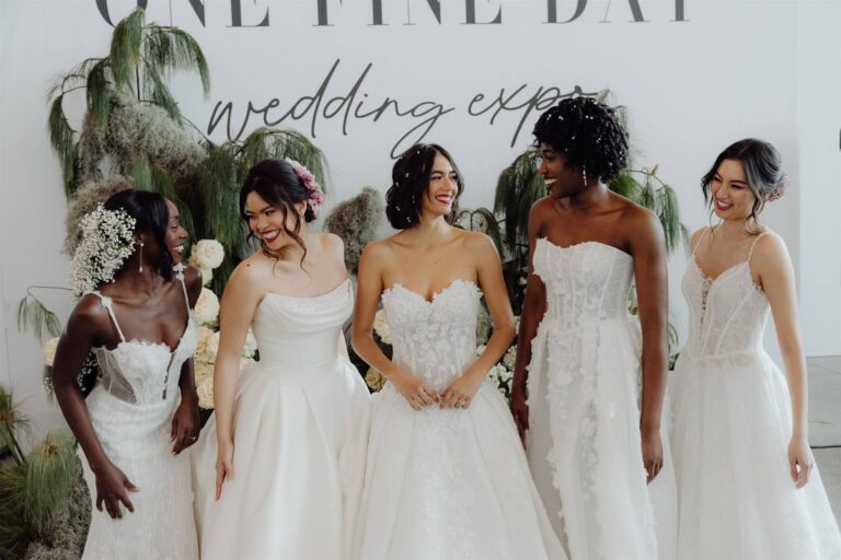 Five bridal runway show models laughing together at wedding expo in Sydney 2025