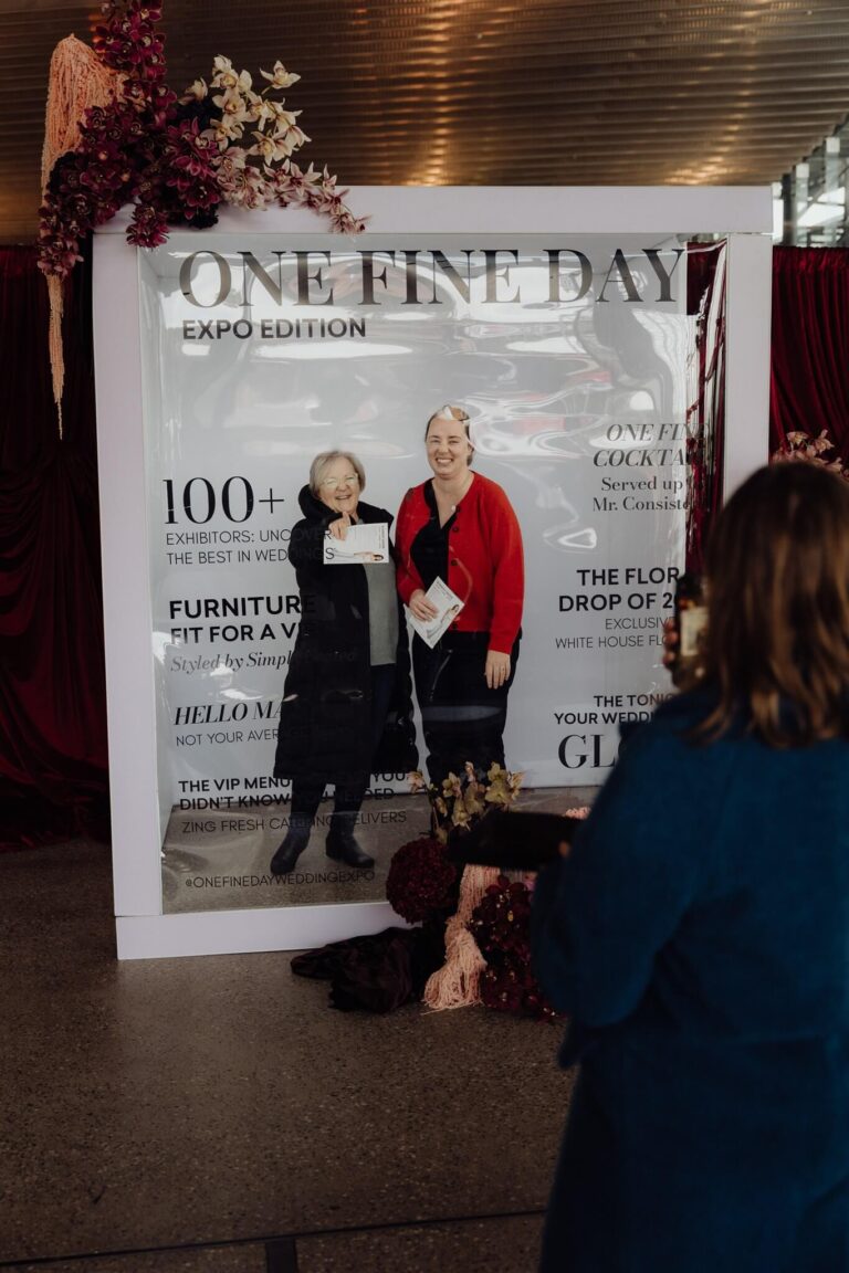 Visitors enjoying photo moment at One Fine Day backdrop frame booth at wedding expo Sydney 2025