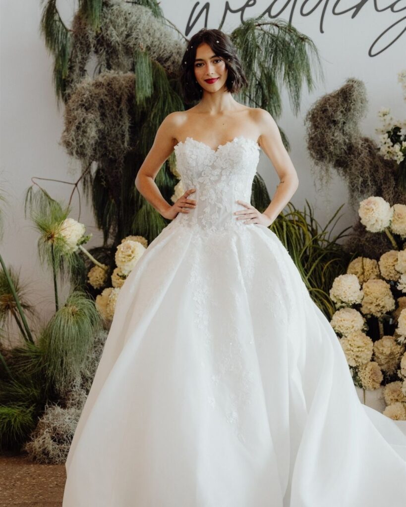 Model wearing strapless lace ball gown in tube cut during bridal runway show in Sydney 2025