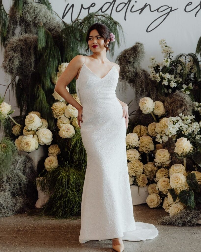 Model wearing fitted spaghetti strap lace gown at bridal runway show in Sydney 2025
