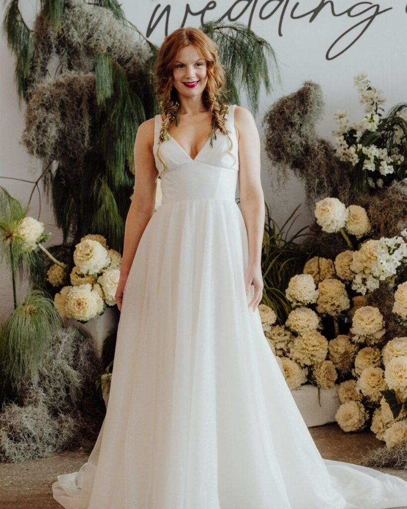 Close-up of deep V neckline on sleeveless satin gown during bridal runway show in Sydney 2025