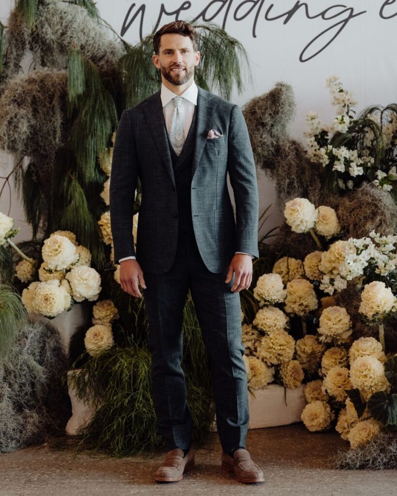 Male model wearing dark customised suit and pants at bridal runway show in Sydney 2025