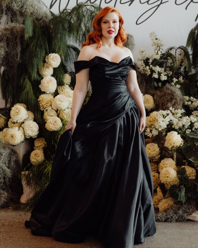 Close-up of black off-shoulder satin dress detail during bridal runway show in Sydney 2025"