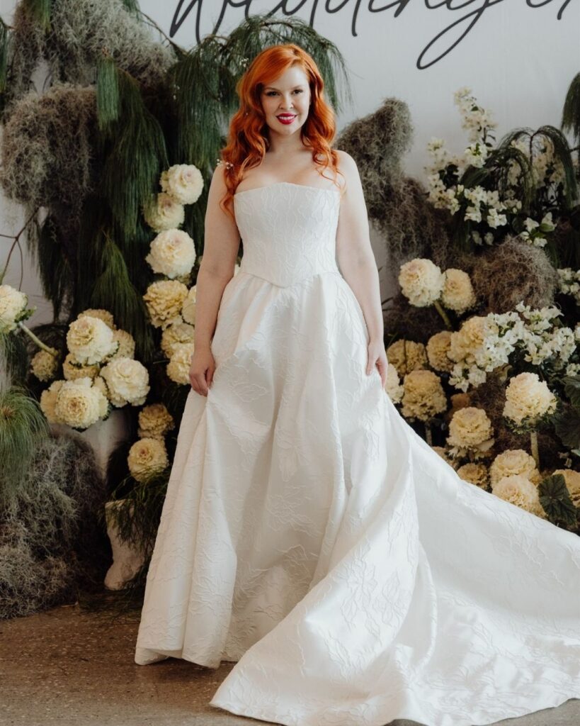 Model showcasing fitted tube-style jacquard dress at bridal runway show in Sydney 2025