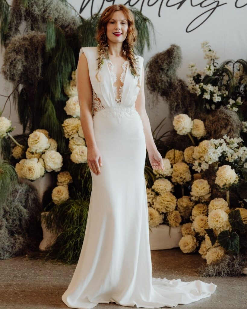 Close-up of lace side detailing on deep V bodice satin gown during bridal runway show in Sydney 2025