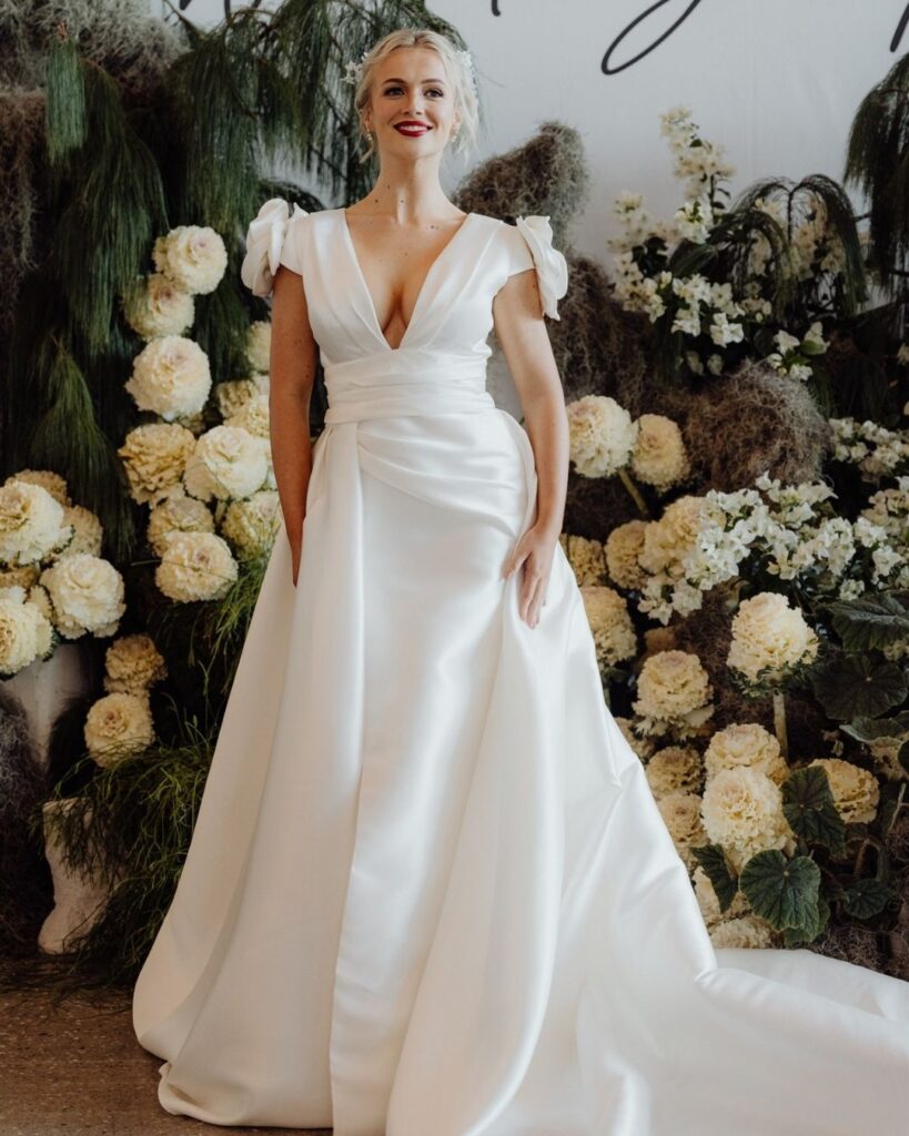 Close-up of deep V-line neckline on satin dress during bridal runway show in Sydney 2025