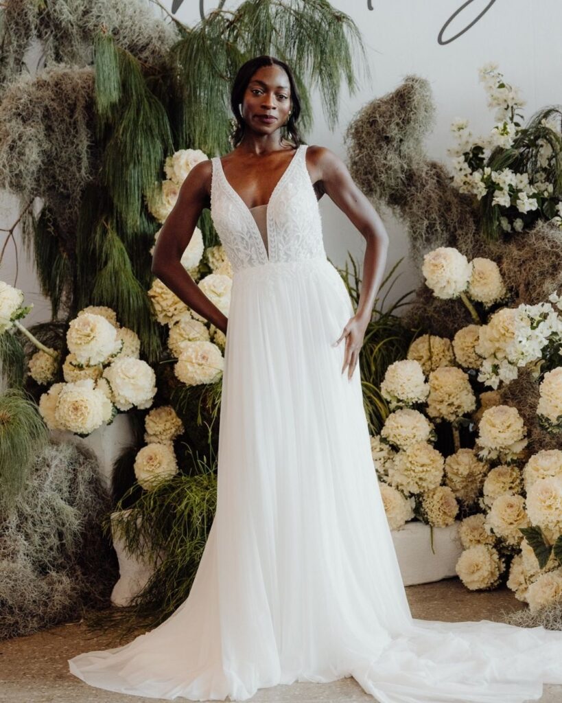 Bridal runway show in Sydney 2025 featuring a model in deep V lace bodice dress with flowing satin skirt