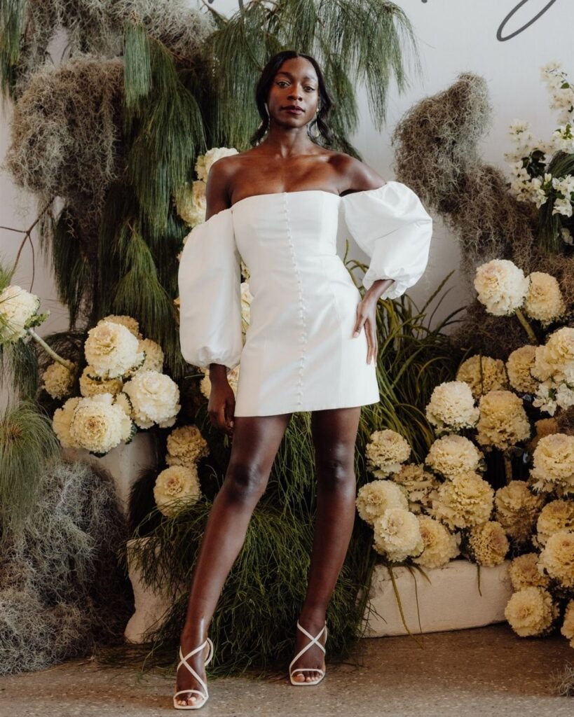 Model wearing tube-style dress with balloon sleeves and above-the-knee length at bridal runway show in Sydney 2025