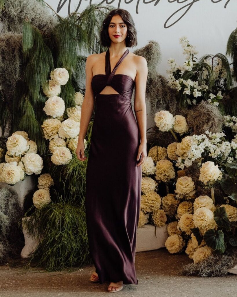 Model wearing dark maroon satin bodice dress at bridal runway show in Sydney 2025
