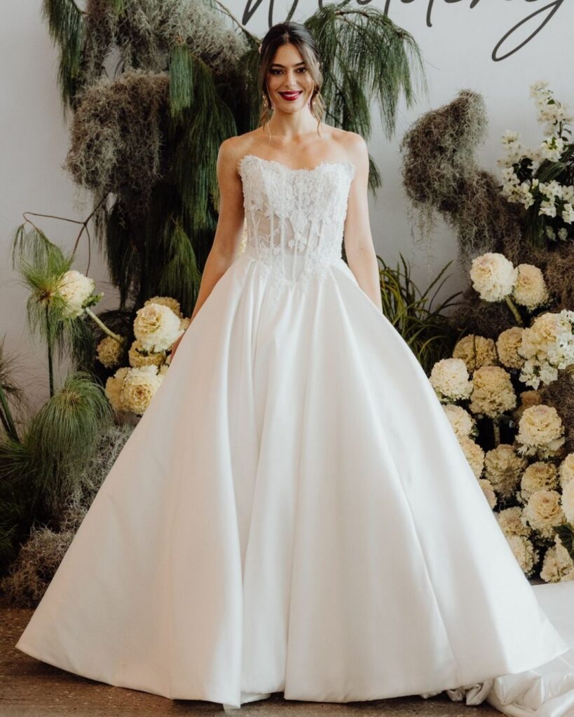 Close-up of tube-style lace upper and satin lower fabric on ball gown during bridal runway show in Sydney 2025