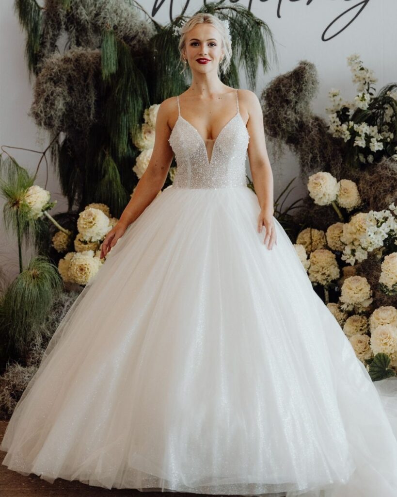 Close-up of deep V-line neckline on chiffon ball gown during bridal runway show in Sydney 2025