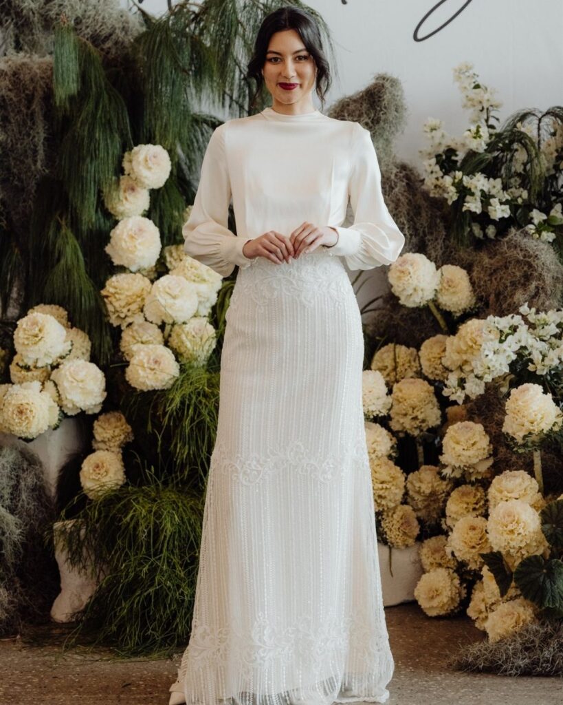 Close-up of long sleeve detail on floor-length dress during bridal runway show in Sydney 2025