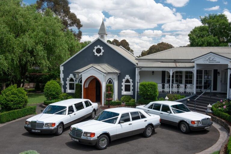 Fleet of three luxury wedding cars at the venue entrance by E&R Classics Wedding Car Hire in Melbourne.