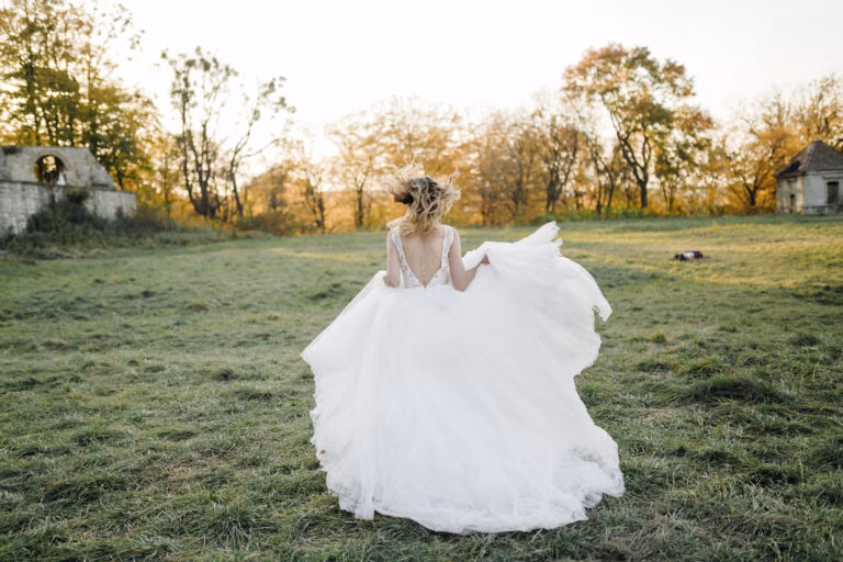 A bride wearing a repurpose wedding dress running on a garden wedding venue