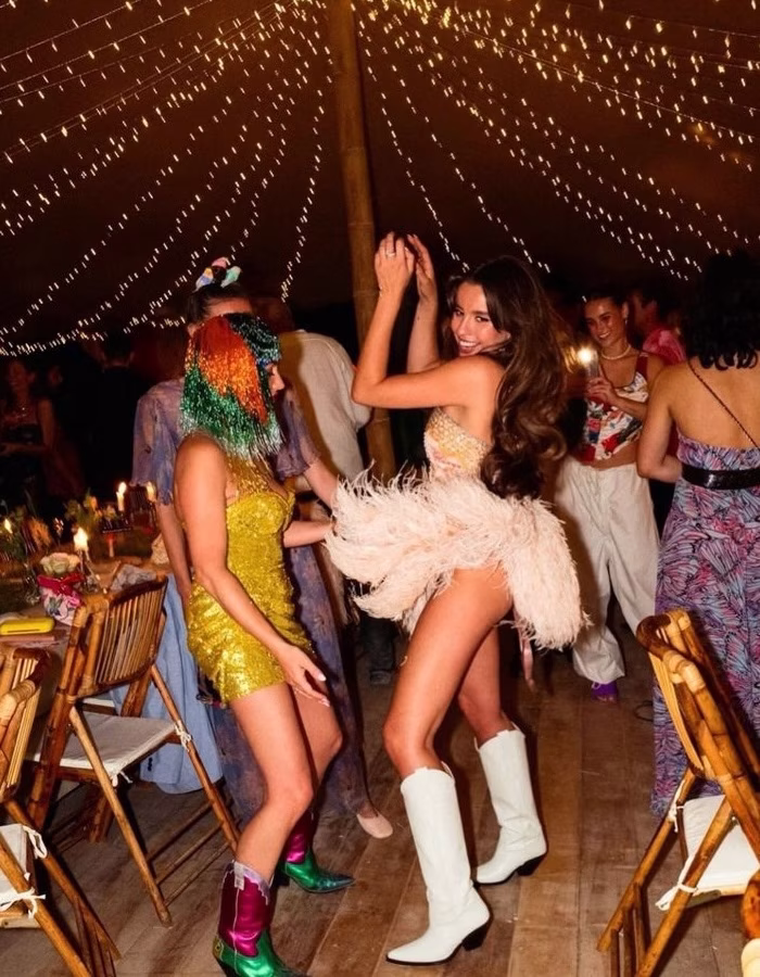 A bride in a feathered skirt dancing at a hens party