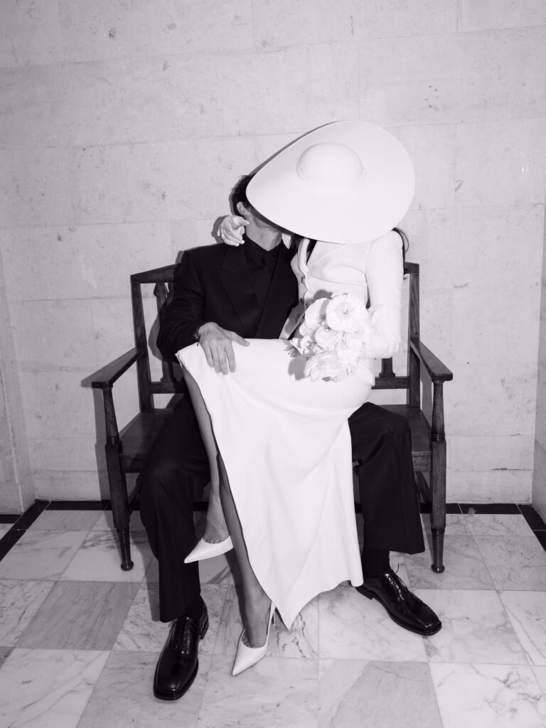 Dua Lipa's wedding in London, showing her kissing husband Callum Turner, her face away from the camera