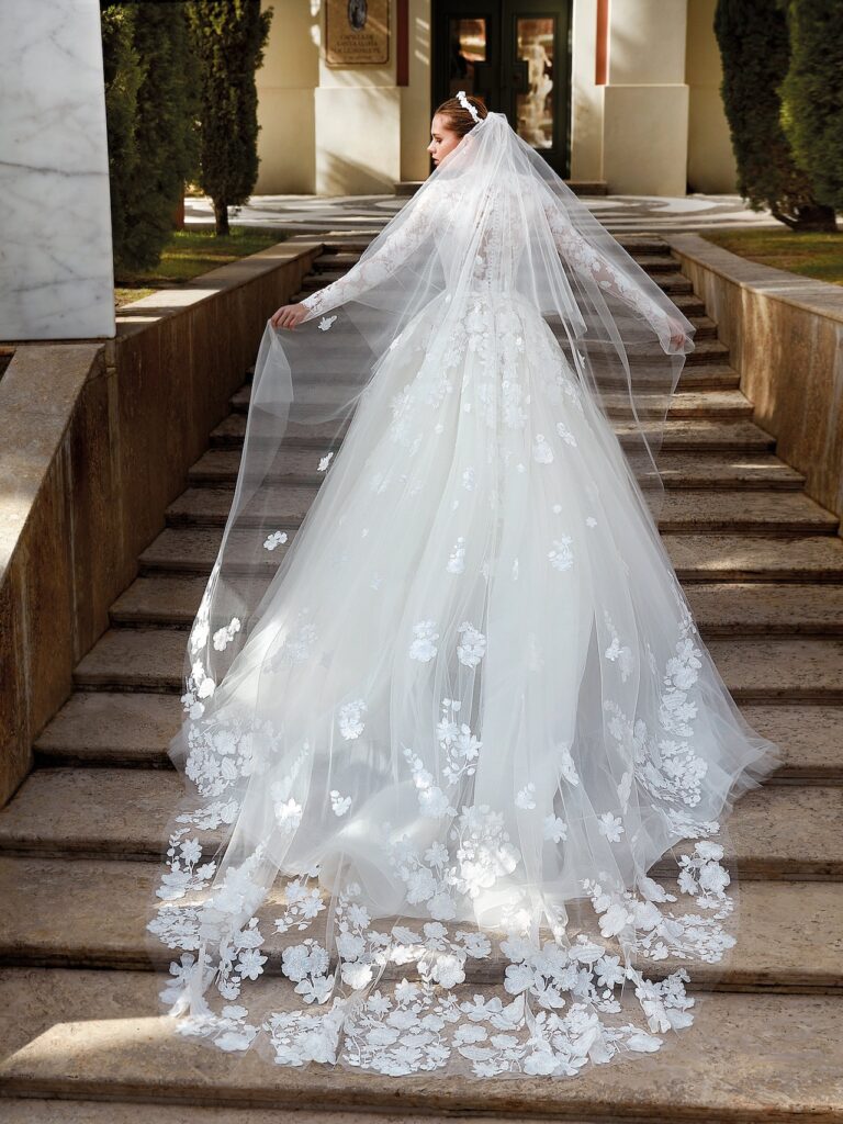 A Dior bride in a haute couture gown and veil