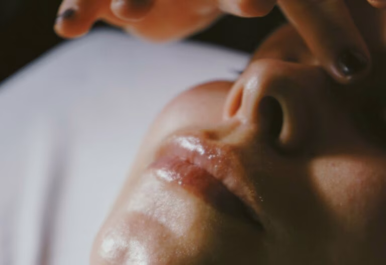 A woman getting a facial consultation, something often done in a wedding skincare timeline