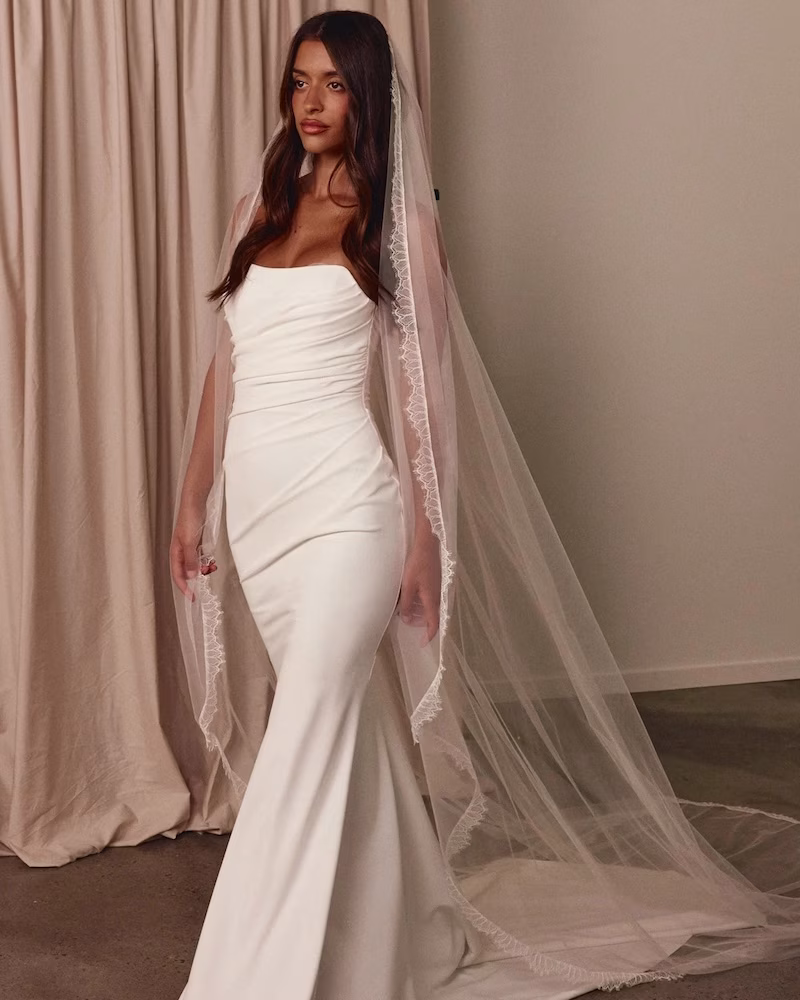 A bride in a cathedral veil, one of the best bridal accessory trends