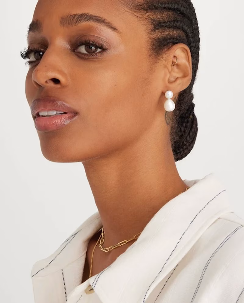 A woman wearing natural pearl earrings