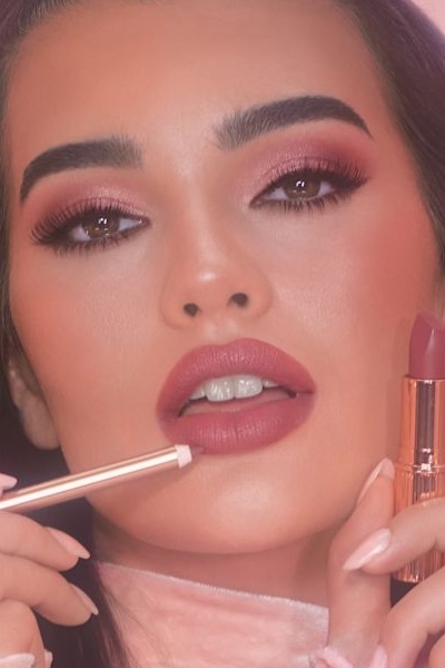 Pillow talk medium lipstick shown on a model