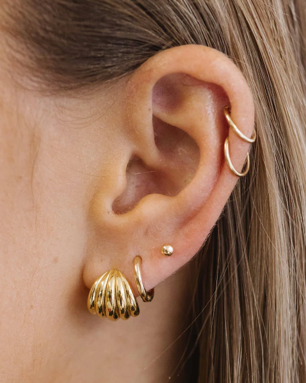 A simple bridal ear stack with gold jewellery